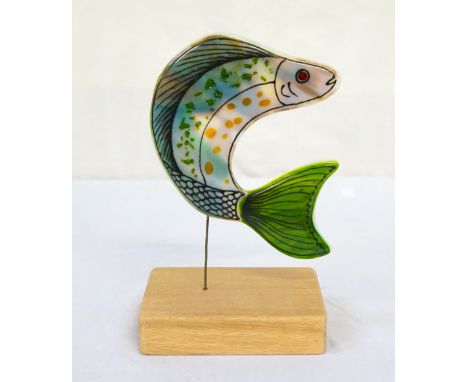 'LEAPING FISH' HAND-MADE FUSED GLASS SCULPTUREthe hand-made glass fish decorated in greens and blues on a wooden base, 25cm h