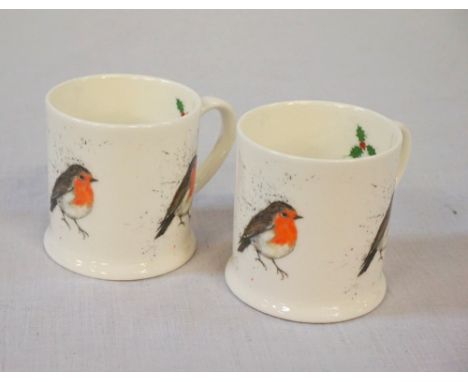 PAIR OF CLARE BROWNLOW COFFEE CANS decorated with festive robins and hollyNote: Clare Brownlow studies at Edinburgh School of