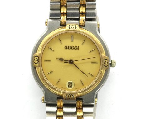 Gucci: ladies wristwatch with gold face, date aperture at 6 o clock and bi-tone bracelet, not working at lotting. P&amp;P Gro