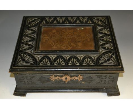 A 19th century Continental ebonised table box, hinged cover with inset etched copper panel, the border and sides chip-carved 