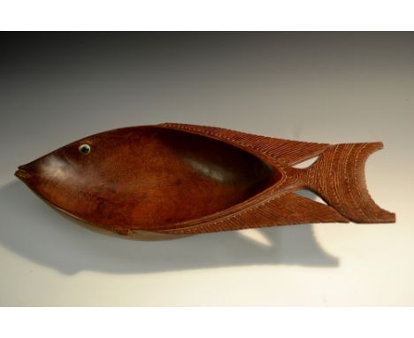 Tribal Art - a Trobriand Islands hardwood food bowl, carved as a stylized fish, shell eye, the fins and tails with geometric 