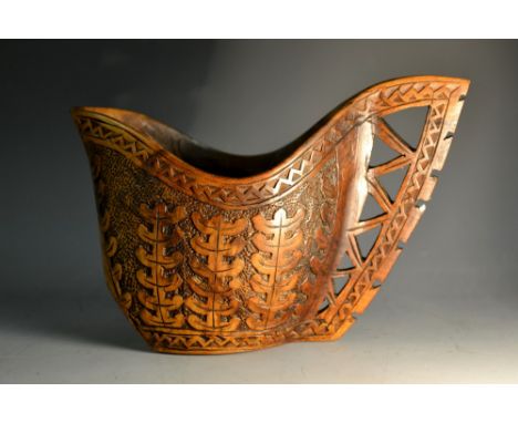 A Scandinavian treen kovsh, carved with stylised foliage, the handle geometrically pierced, 10.5cm high, 20th century