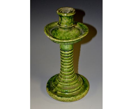 A 19th century green ware candlestick, campagna sconce, broad dished drip pan, stepped columnar foot, 21.5cm high 
