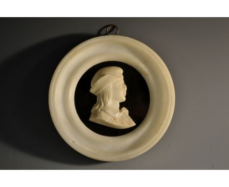 A 19th century alabaster portrait roundel, of John Calvin (1509-1564), turned frame, 12.5cm diam, c.1870