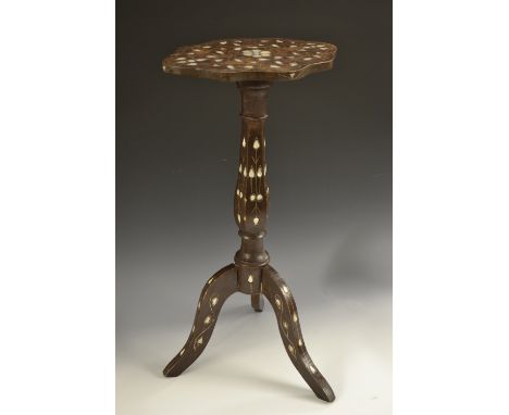 A Middle Eastern hardwood and marquetry tripod kettle stand, shaped oval top, panelled baluster column, profusely inlaid in m