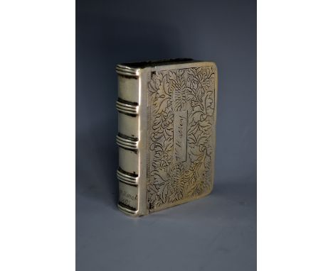 A 19th century silver-coloured metal novelty snuff box, as a book, hinged cover engraved with leaves and inscribed W. Massey,