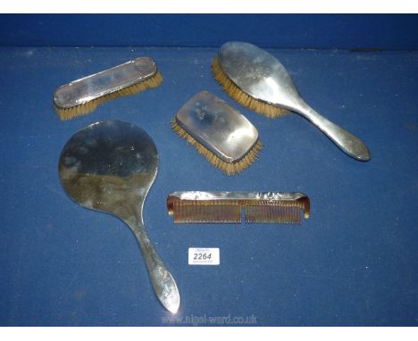 A Birmingham silver dressing table set including mirror, two brushes and comb 1929 by H&amp;H Ltd.