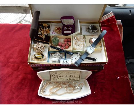 A cardboard jewellery box containing; faux pearl necklaces, amethyst and gold plated cufflinks, two Limit watches, miscellane