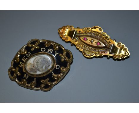 A Victorian black enamelled and and hair work mourning brooch, central oval aperture inset with a hair work and gold thread p