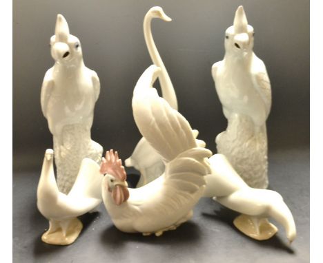 A Lladro model of a cockerel; three Nao geese; a pair of Chinese export parrots (6)