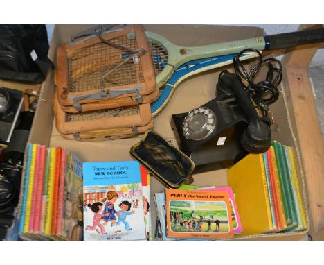 A dial-up telephone; a purse containing copper pennies; an oval mirror; books including Ladybird and Thomas the tank engine ;