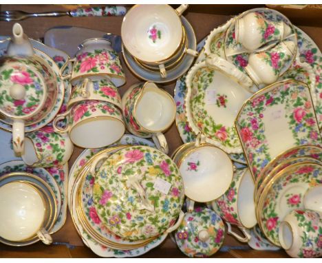 A Staffordshire floral tea service comprising, cake plate, cups and saucers, tea plates, side plates, milk jug and sugar bowl