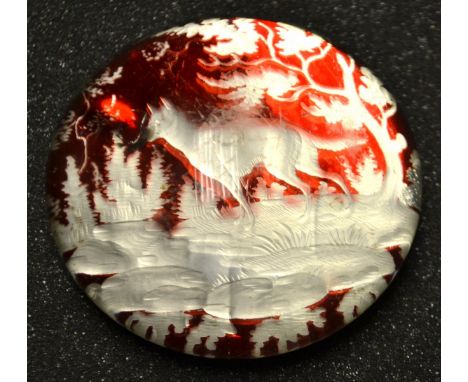 A 19th century Bohemian ruby glass paperweight, dog in a landscape
