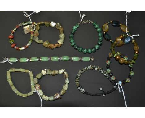 A Chinese stained green jade effect and white metal eight panel bracelet;  a jade and quartz encrusted woven multi-bead brace