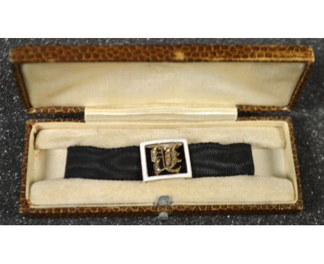 An Edwardian 9ct gold enamelled and old cut diamond mounted initial bracelet, capital B , white enamel frame, boxed 