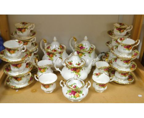 A Royal Albert Old Country Roses tea service, including three tea pots, bread and butter plates, milk, sugar etc