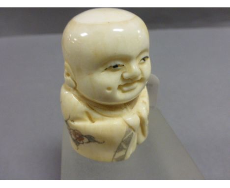 Signed bone netsuke of a Buddha Boy in cloak      