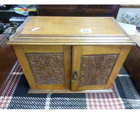 Early 20th century Oak Smokers Cabinet with Carved Panel Doors