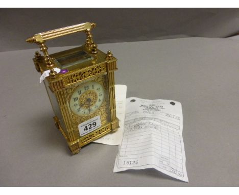 Early 20th century Gilt Brass Carriage Clock with Fretwork and receipt for repair
