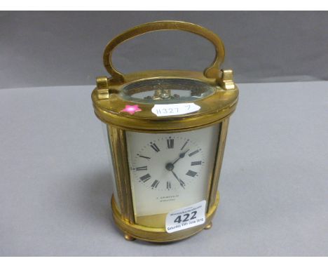 Early 20th century Oval Cased Carriage Clock marked to enamel dial ' E Grimes & Co Bidgford '