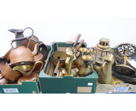 A large quantity of antique and later brass and copperware to include a hanging oil lamp, pierced trivets, various jugs, kett