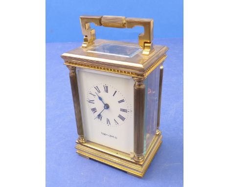 A heavy gilt-metal carriage clock by Mappin &amp; Webb Ltd; white dial with Roman numerals flanked by classical-style fluted 