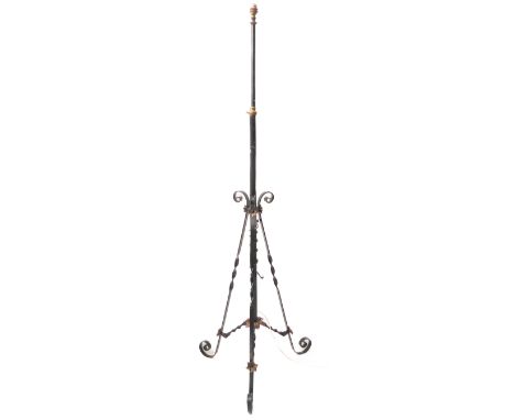 A wrought-iron black-painted lamp standard base with wrythen tripod base