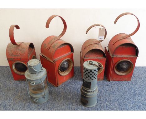 An interesting selection of six lamps comprising four red-painted roadwork lamps and two,&nbsp;possibly military, lamps: 'The