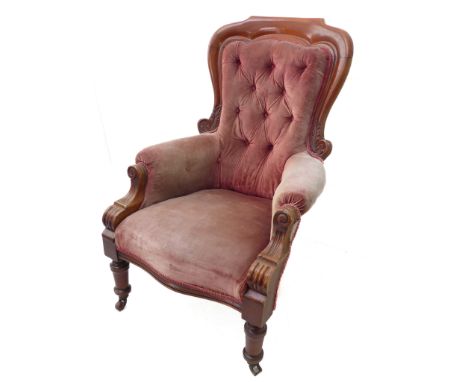 A mid 19th century faded pink button velour upholstered and mahogany show-framed spoonback armchair of large proportions; flu