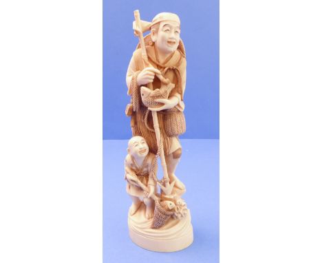 A well-carved early 20th century Japanese Okimono figure of a fisherman and attendant boy, seal mark to underside (26cm) (rep