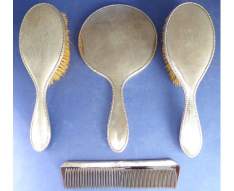 A circa 1914 Walker and Hall hallmarked silver dressing table set comprising a pair of silver-backed hair brushes, a handheld