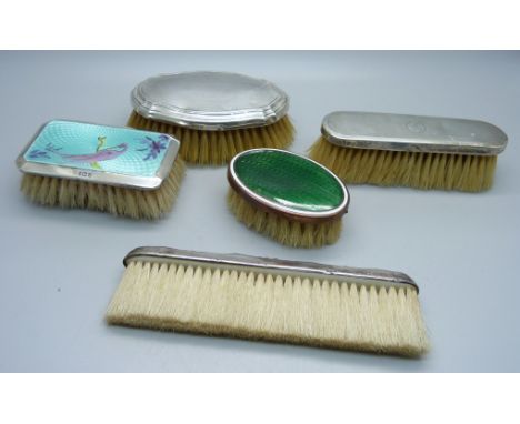 Four silver mounted brushes including one enamel and one other brush 