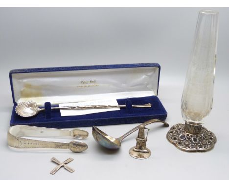 A pair of silver sugar bows, silver spoon, silver base vase, silver ladle and a white metal model of a windmill, 77g 