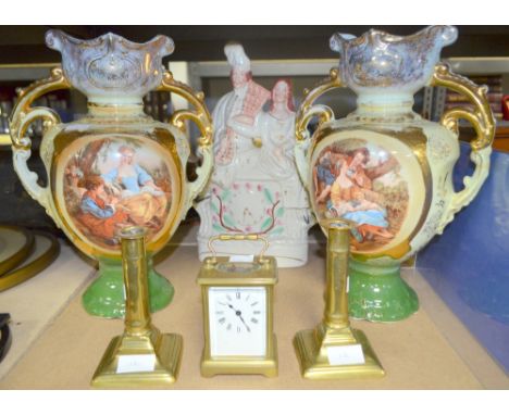 French brass carriage clock and a pair of early 19th century brass candle sticks. Staffordshire flatback and a pair of vases.