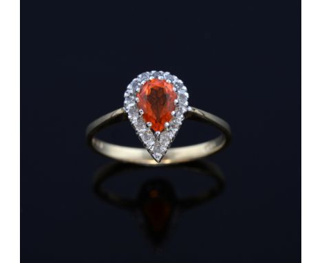 Diamond and fire opal ring, the pear form stone within a border of diamonds