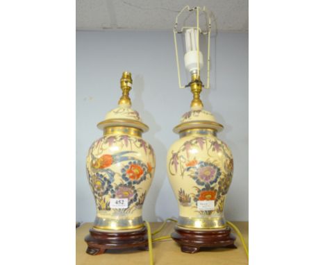 Pair of Chinese ceramic lamps decorated with flowers and exotic birds.