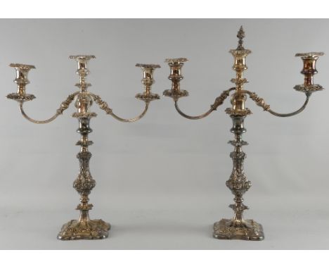 Pair of foliate cast old Sheffield plate three light candelabra, the scrolling branches to a single candle stick, 47cm high,