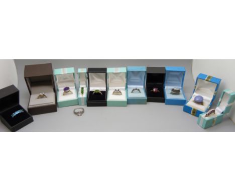 A collection of stone set silver rings including opal 