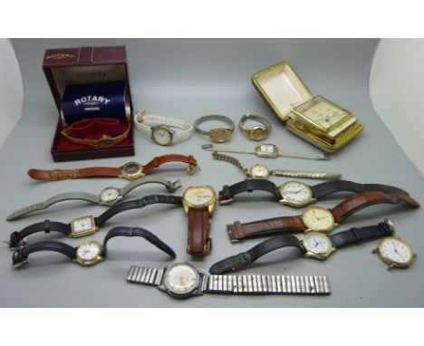 A collection of wristwatches and a travel clock 