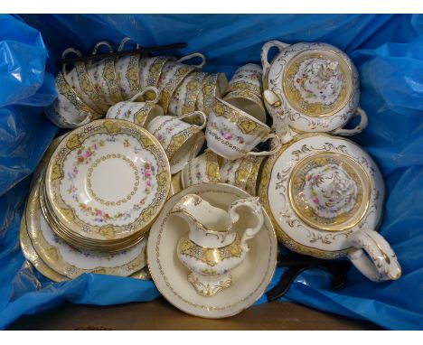 An Edwardian porcelain tea set, sixteen cups, eleven saucers, tea pot, lidded sugar pot, cream jug, plate and slop bowl **PLE