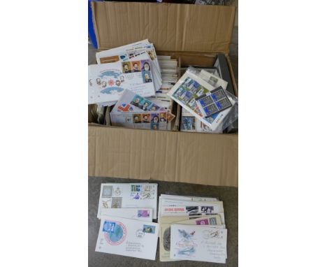 A box of approximately 200 first day covers and loose stamps 