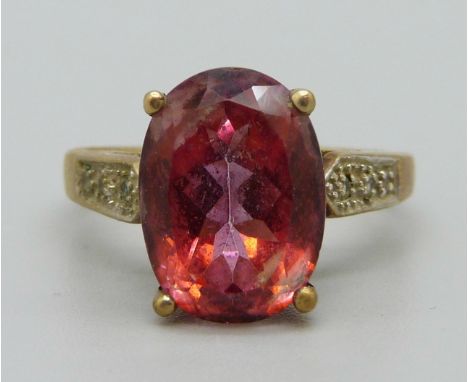 A 9ct gold ring set with a red stone, 5.4g, T 