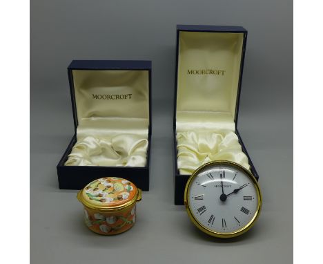 A Moorcroft enamel circular box, circular box with clock and a Moorcroft clock dial and movement, boxed 