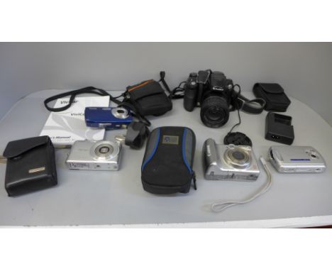 A Fuji Finepix S5600 camera and four other cameras 