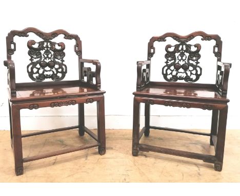 A pair of 19th century rosewood Hongmu armchairs, the splats carved and pierced with pears dragon design with the arms having