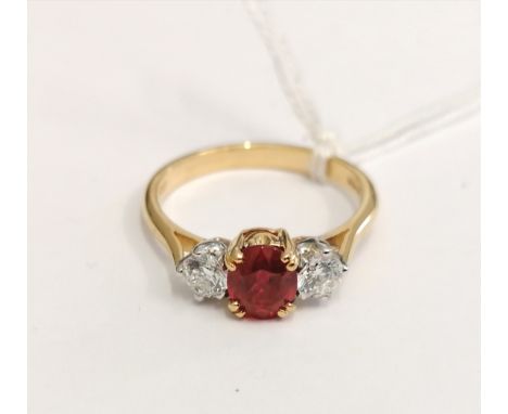0.750 (18ct) Three stone ruby and diamond ring, diamonds 0.45cts approximately. London 1962.
