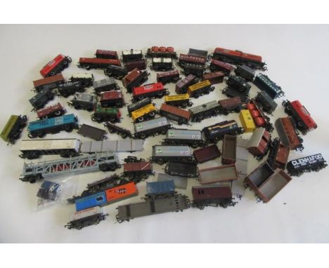A large quantity of goods rolling stock by Hornby, Bachmann and others including car transporter, tank wagons, coal truck and