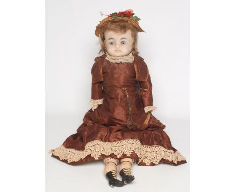 A 19th century wax shoulder head doll, with fixed glass eyes, closed mouth, light brown wig, composition lower arms, composit