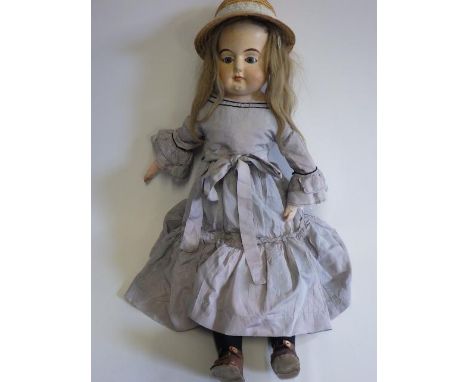 A 19th century composition shoulder head doll, with fixed blue glass eyes, closed mouth, light brown wig, composition lower l