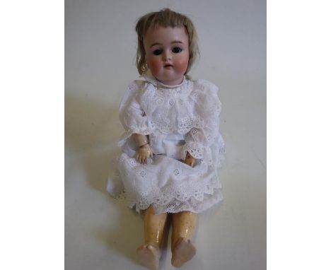 A Kammer &amp; Reinhardt bisque socket head doll, with brown glass sleeping eyes, open mouth and teeth, pierced ears, composi